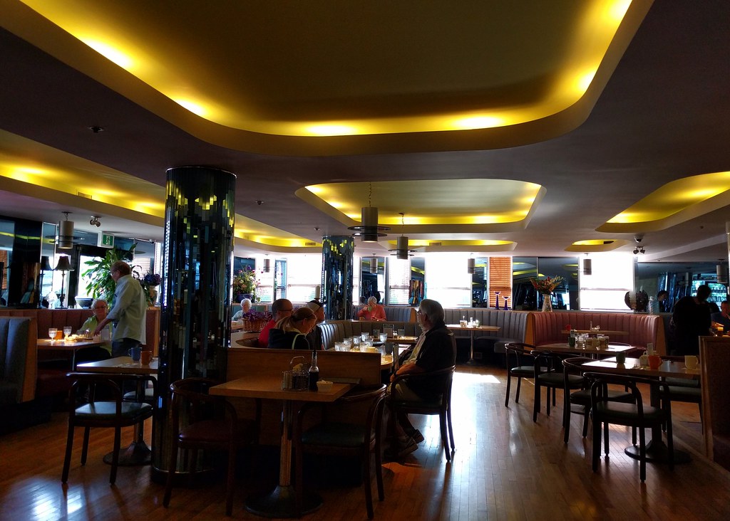 Modern restaurant interior with ambient ceiling lights and dining tables